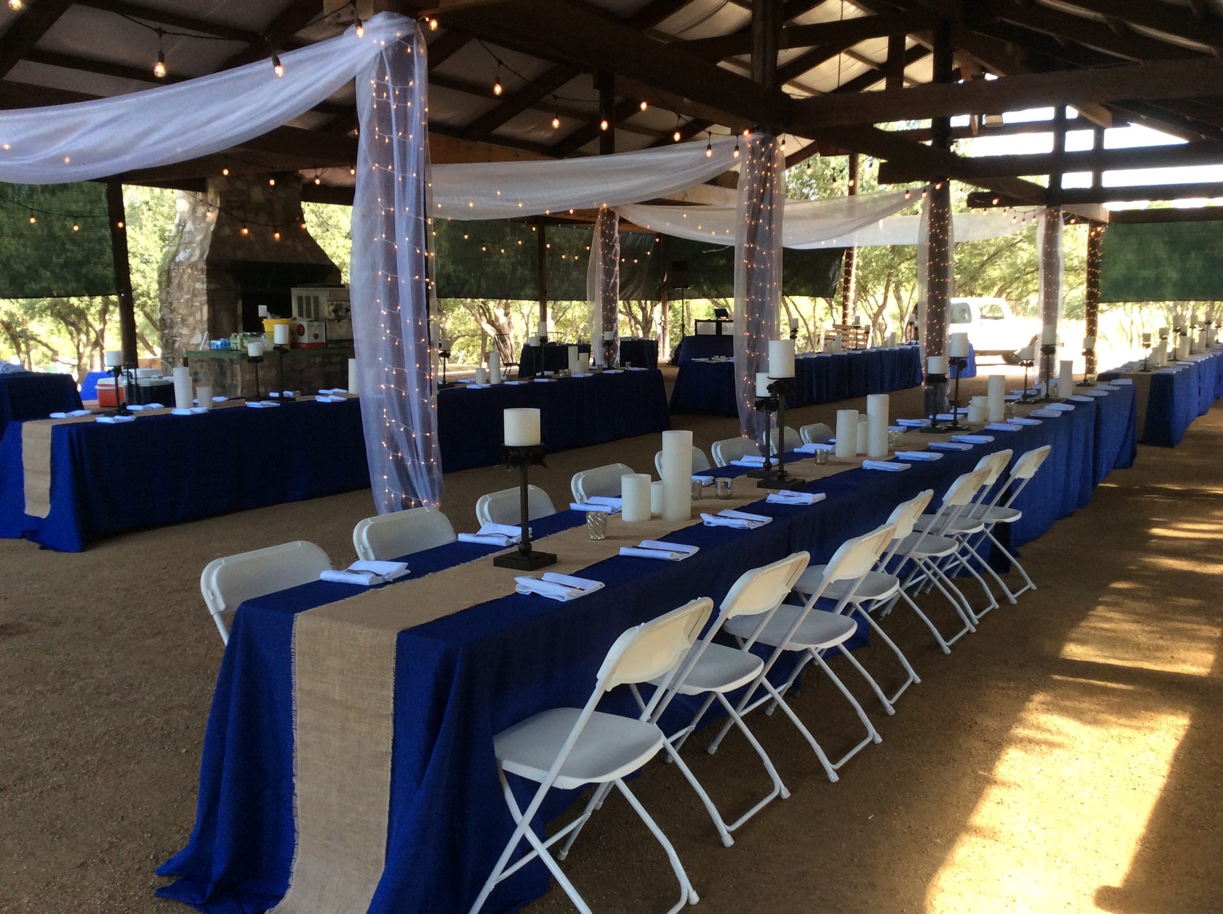 Long reception tables set with navy linens